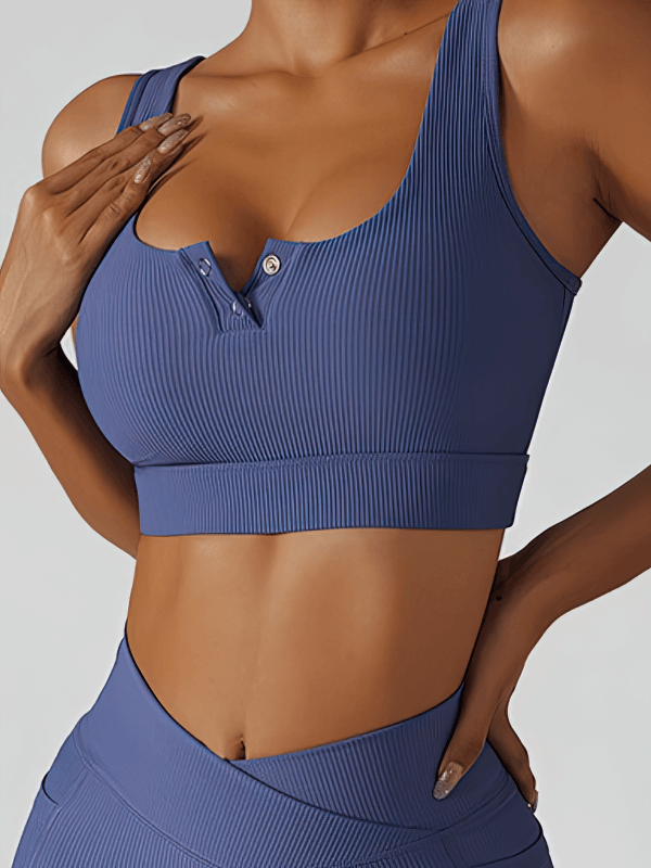 Woman wearing a stylish, elastic sports cropped top in navy blue, ideal for yoga and active wear, showcasing breathable and quick-dry features.